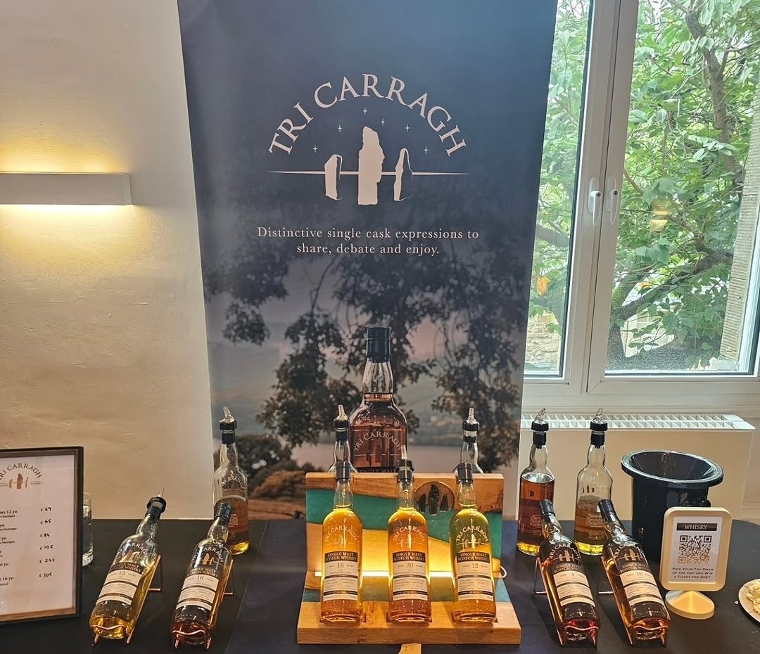 The Trio whisky display in use on the Tri Carragh stand at the Linlithgow Whisky Festival beside their banner and bottle line-up